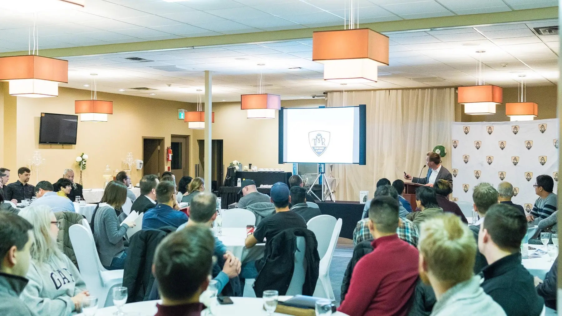 A Team Made Hub educational session with a presenter and a full room of attendees